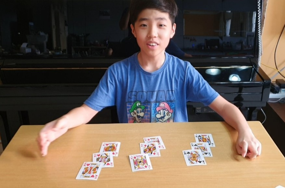 Isaiah performing magic tricks, which he learnt from YouTube, for his family.