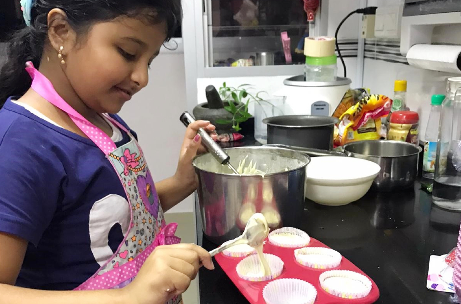 Amelia baking up a batch of vanilla cupcakes