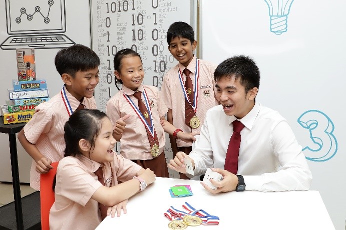 Mr Goh guiding students to play the multiplication flash card game