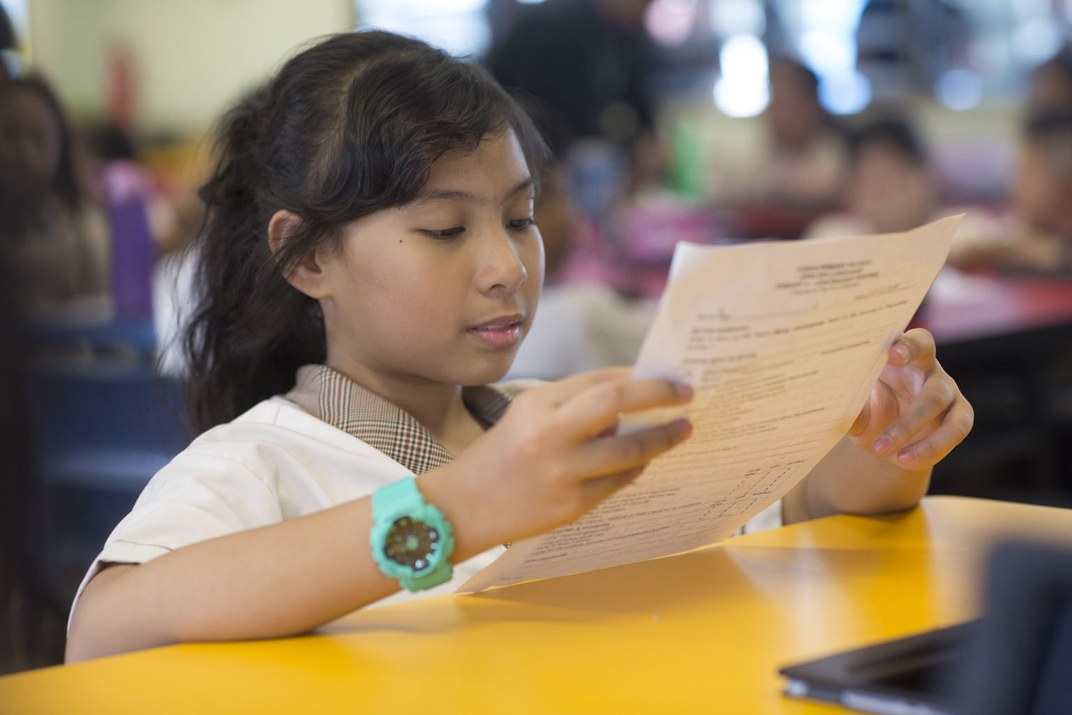Stock Image: A primary school student working on an activity sheet