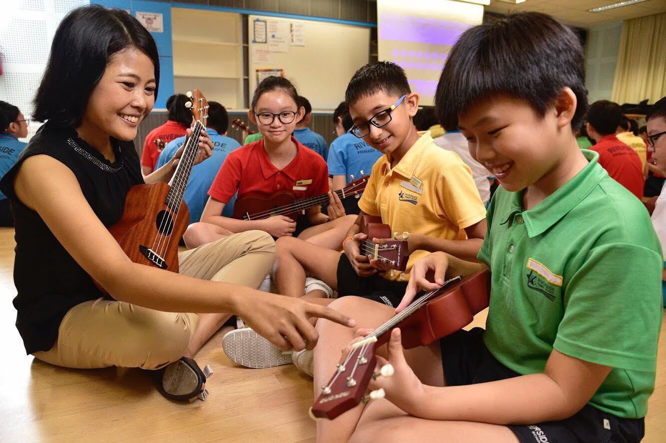 Ms Ameerah makes music with her students. (Photo taken before COVID-19.)