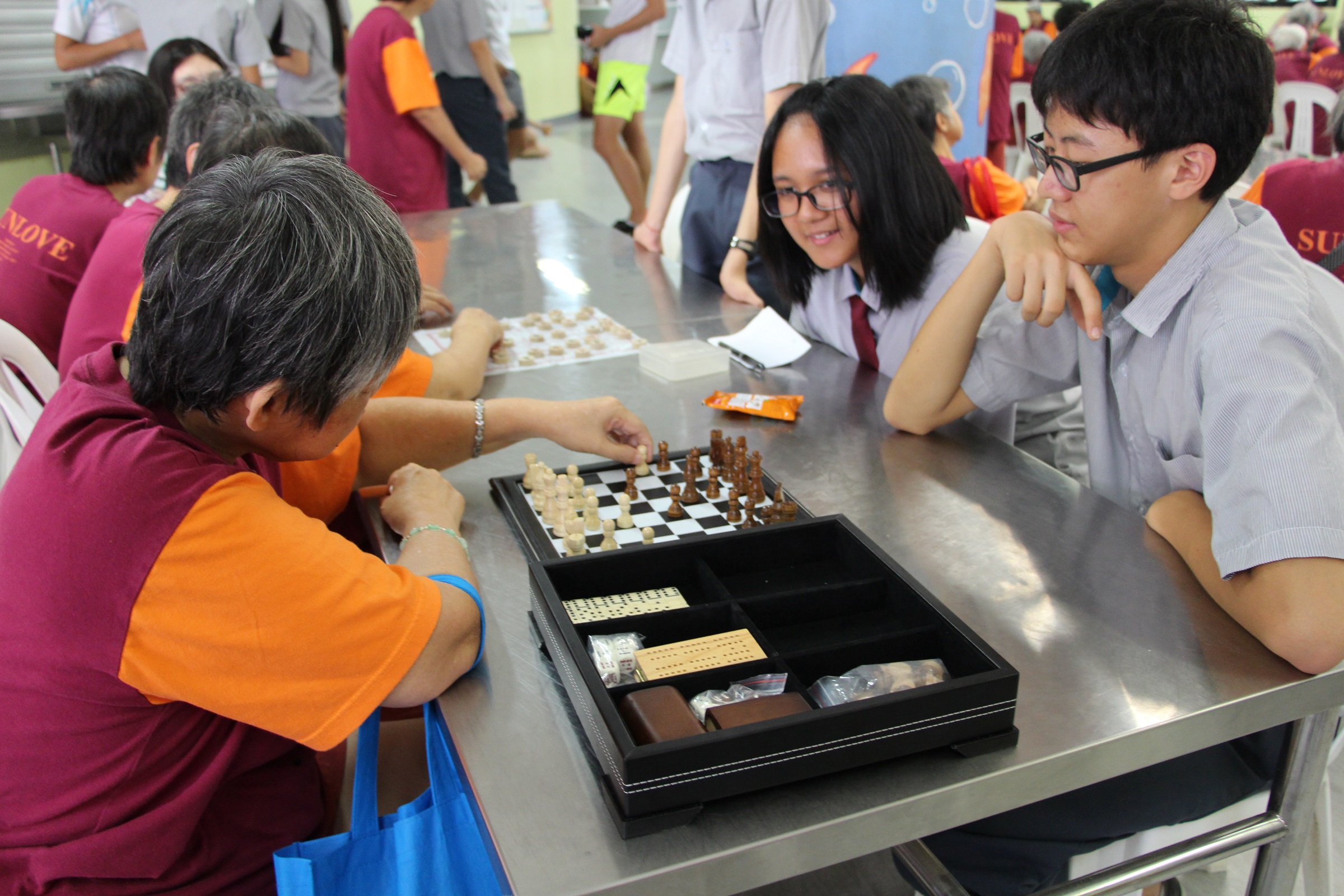 Total Defence is as much about building bonds: Students of Bowen Secondary play chess with residents of Sunlove Home. (Photo credit: Bowen Secondary School)