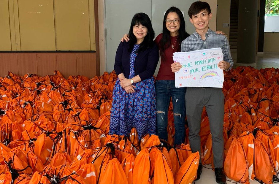 Dr Shirleen Chee on the left, overseeing the COVID-19 care packages assembled by the ACJC students. 