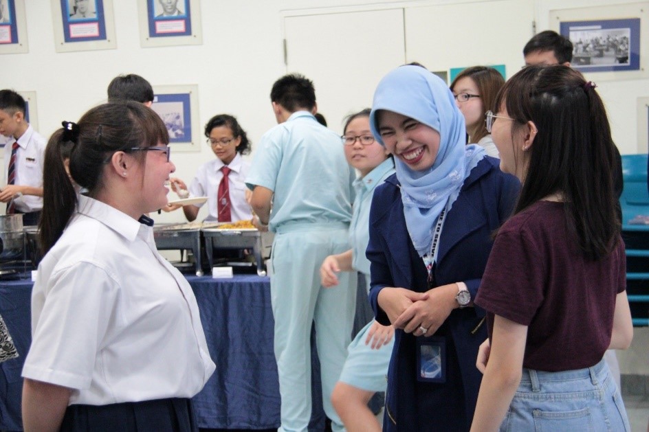 Mdm Rasidah Bte Rahim, Principal of Queenstown Secondary School, with her students. Through her everyday interaction with her students, Mdm Rasidah is convinced that they are not the ‘strawberry generation’ that people assume. (Photo taken before COVID-19)