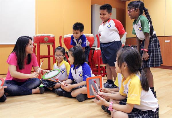 Ms Sheena Toh encourages her Primary One pupils to play rhythm patterns on Sound Shape, designed for users to play, compose and share music. 