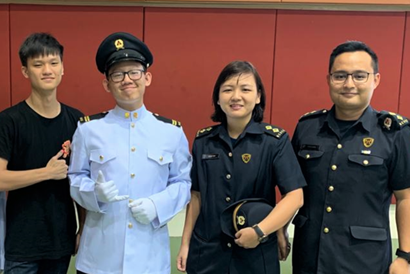 Jun Xian (second from left), and his teacher-officer, Ms Kiew (third from left), at his Cadet Lieutenant Course Graduation Ceremony in 2019.