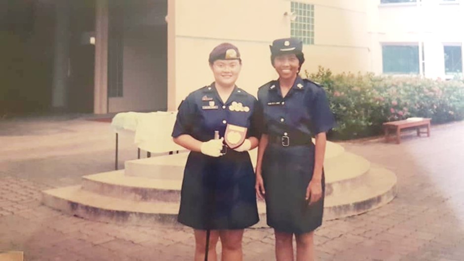 Sio Hoon (left) with her NPCC teacher-officer Ms Fauziah during her Passing Out Parade in 1998. 