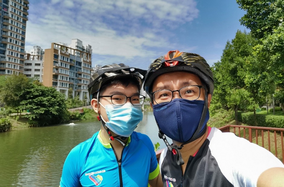 Sage (left) training for a fundraising cycling event Ride for Rainbows with his father Thomas (right).