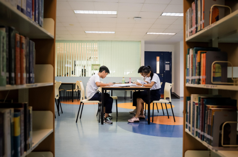 Stock image: JC students studying in their school library.