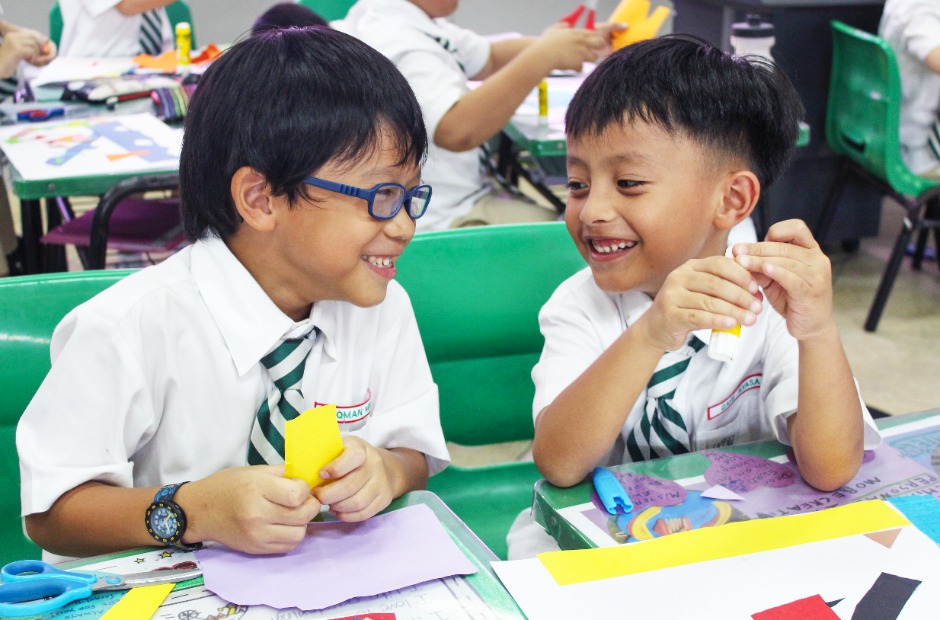 Stock image: Primary school children enjoying their art lessons.