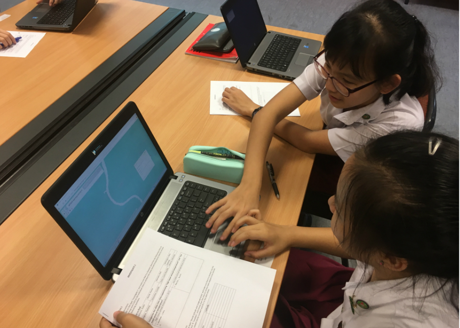 Students from Bukit Panjang Government High School learning about weather and climate using a digital map on ArcGIS Online.