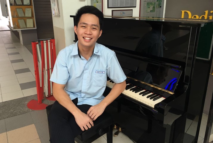 The school-hall piano, where Tan Ou Wen first picked out simple tunes to hone his love of music, before starting to perform. (Photo credit: Ezekiel Ng)