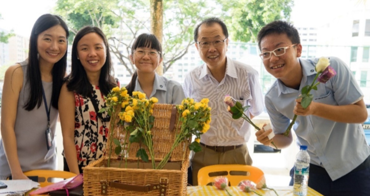 Ms Yip Yong Kit (left) with her colleagues and students at a fund-raising event where her students managed to put what they learnt in Principles of Accounts to good use.