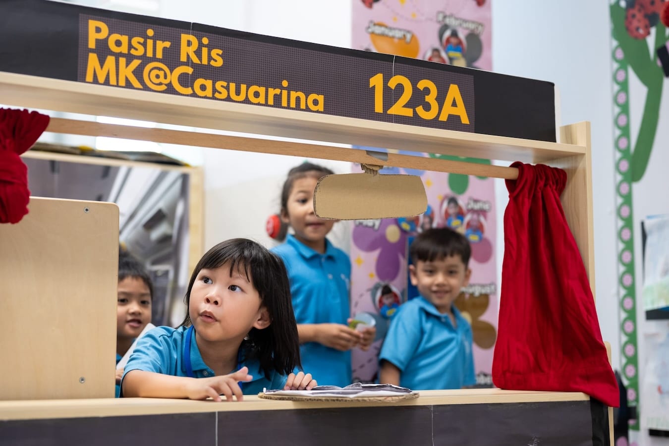 kindergarteners playing make-believe on an imaginary bus