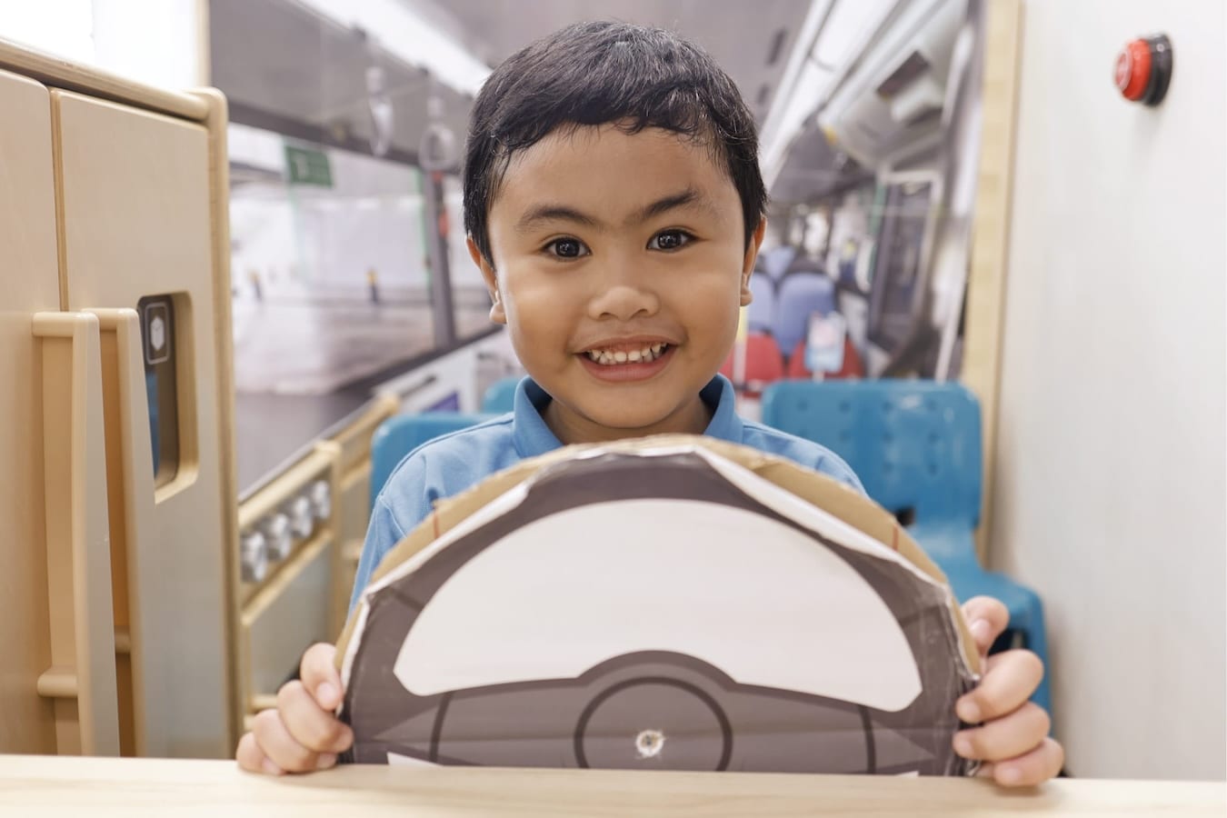 a smiling child as the captain of an imaginary bus